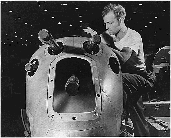 Photo of a worker at the Locheed factory during world War 2 assembling a P-38 Lightning. C 2010 www.zenoswarbirdvideos.com